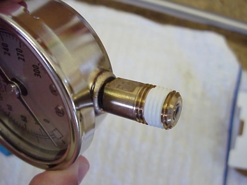 Clean threads on gauge and inside chamber carefully to ensure there is no debris