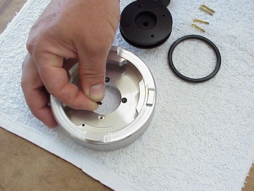 Lubricate each small (size 006) O-Ring lightly with petroleum jelly and place into recessed screw hole