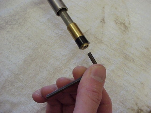 Using the Allen Key, remove the cap screw located at the end of the Piston Assembly