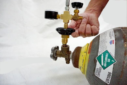 Screwing a 6-Foot Filling Hose into the Master Cylinder