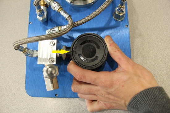 Grasp the back of the gauge and turn Counter-Clockwise to the “un-locked” position